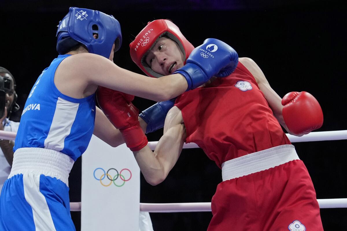 Taiwan's Lin Yu-ting, right, fights Uzbekistan's Sitora Turdibekova in their women's 57 kg preliminary boxing match.