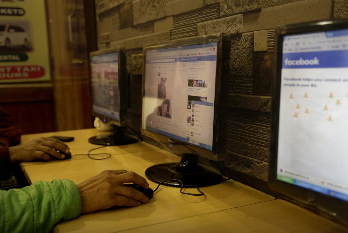 Patrons use the computers at an Internet cafe in New Delhi, India on Feb. 9.