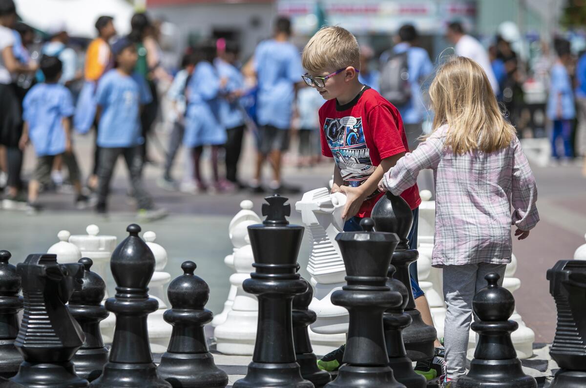Billy and Cora Davenport from Brea play chess during Imaginology 2019 in Costa Mesa. 