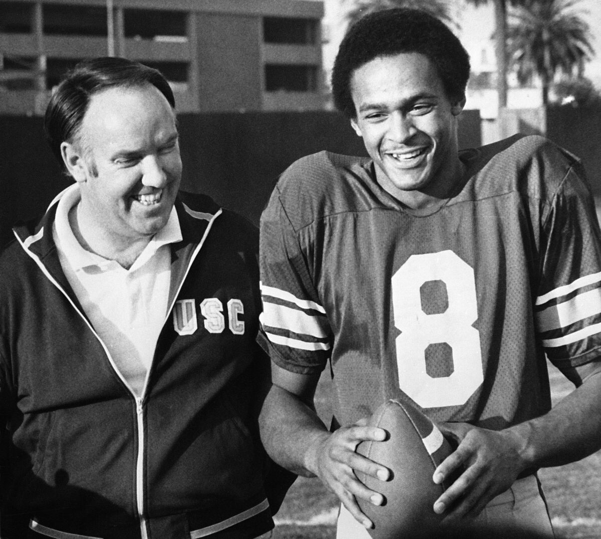 USC head coach John Robinson and quarterback Vince Evans talk in December.  14, 1976, as the Trojans prepared to play Michigan