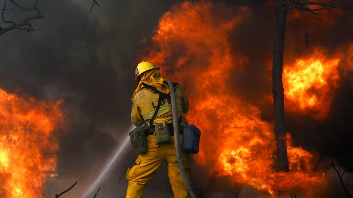 Firefighters try to save a home along in Bel-Air last week.