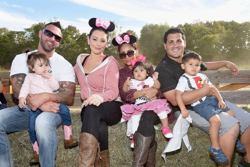 Roger Mathews, left, with baby Meilani Mathews, Jenni "JWoww" Farley, Nicole "Snooki" Polizzi with baby Giovanna LaValle, and Jionni LaValle with baby Lorenzo Dominic Lavalle celebrate the LaValle kids' birthdays with a hayride in September. Farley will have another tot to wrangle by the same time next year.