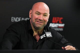 UFC President Dana White at a microphone with a UFC symbol
