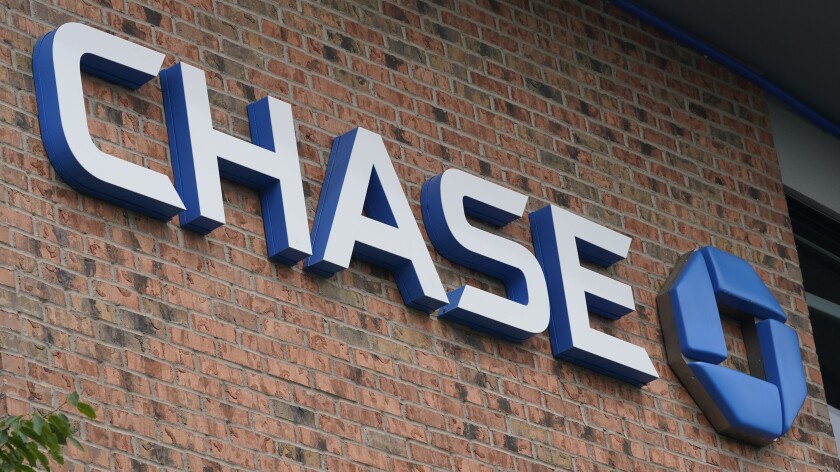 A Chase bank sign is shown in Richmond, Va., Wednesday, June 2, 2021. JPMorgan Chase’s said, Friday, Jan. 14, 2022 its fourth quarter profits fell 14% from a year earlier, as the company saw a weaker performance out of its trading desk and had higher compensation expenses for its employees. (AP Photo/Steve Helber)