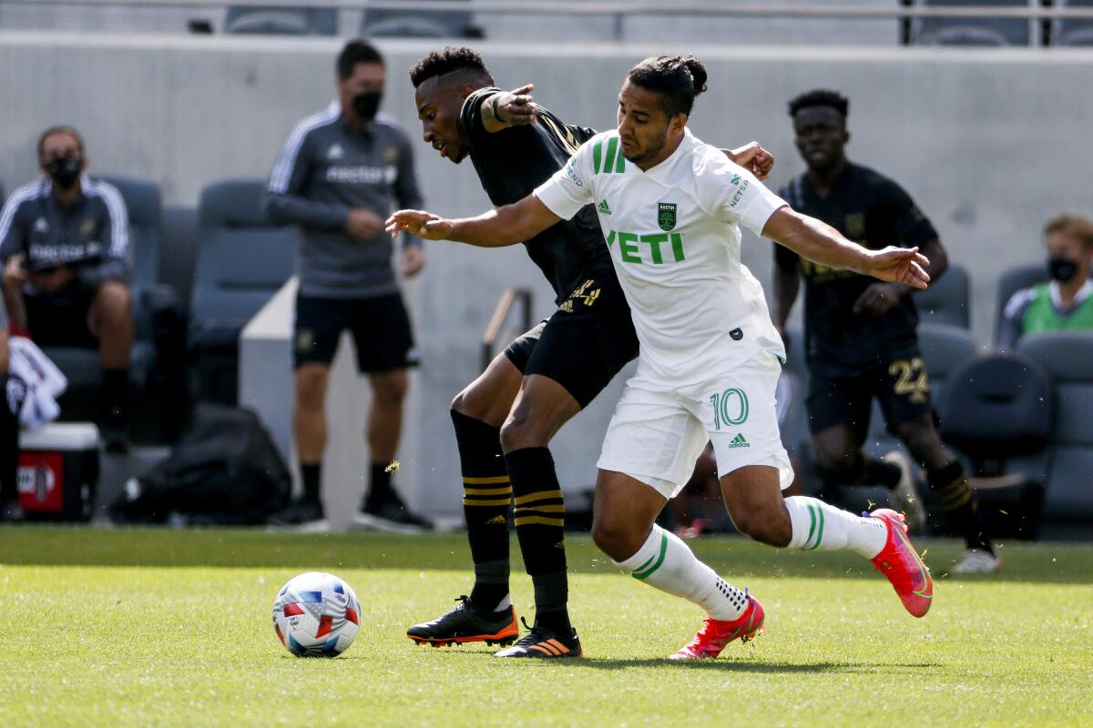 LAFC midfielder Mark-Anthony Kaye, left, and Austin FC midfielder Cecilio Dominguez battle for the ball.