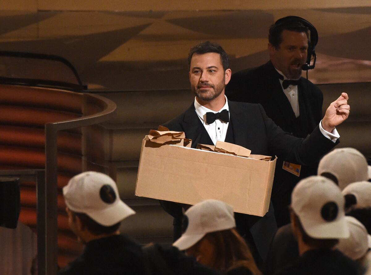 Host Jimmy Kimmel hands out peanut-butter-and-jelly sandwiches during the 68th Emmy Awards show in Los Angeles. 