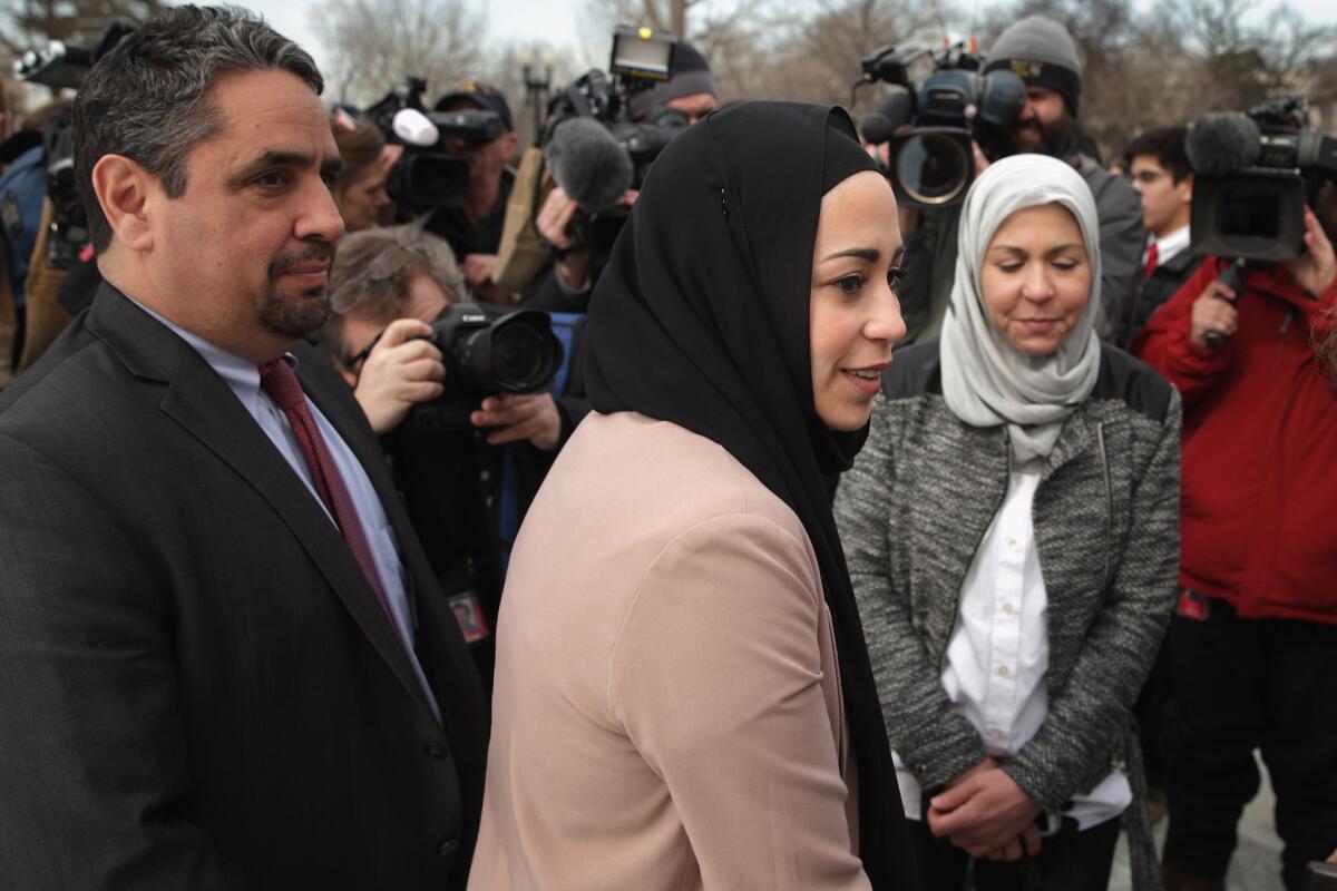 Samantha Elauf, her mother Majda Elauf (right) and Equal Employment Opportunity Commission General Counsel David Lopes (left) are seen outside the U.S. Supreme Court after oral arguments in their case against Abercrombie & Fitch on Feb. 25.