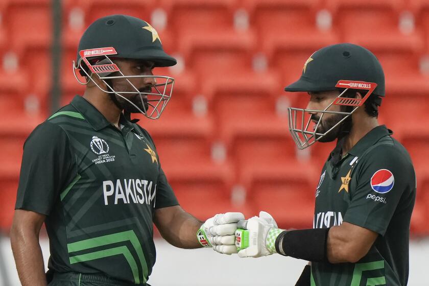 Pakistan's captain Babar Azam, left, and Mohammad Rizwan encourage each other during the ICC Cricket World Cup warmup match between New Zealand and Pakistan in Hyderabad, India, Friday, Sept. 29, 2023. (AP Photo/Mahesh Kumar A.)