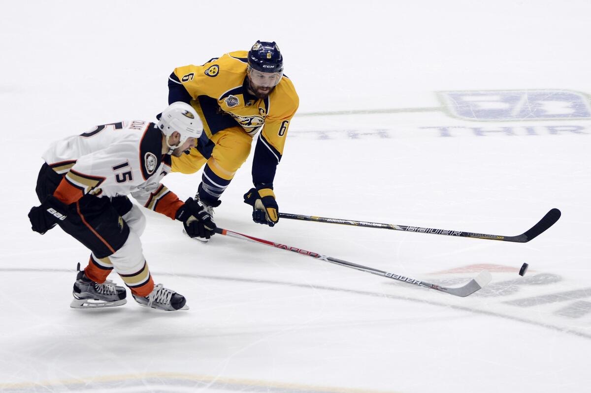 Ducks center Ryan Getzlaf, left, and Nashville defenseman Shea Weber chase the puck on Tuesday night.