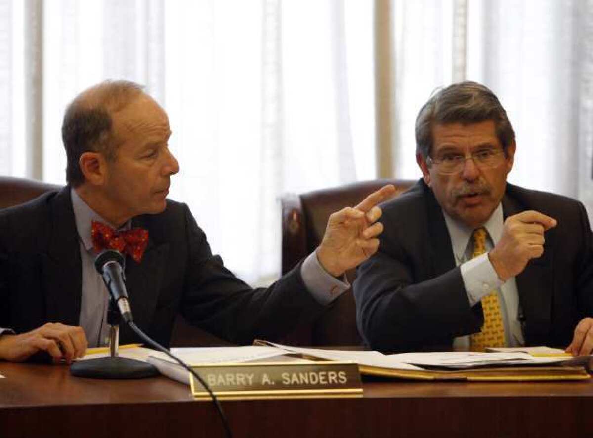 Coliseum commissioners Barry A. Sanders and Zev Yaroslavsky, also an L.A. County supervisor, speak at a December 2010 meeting.