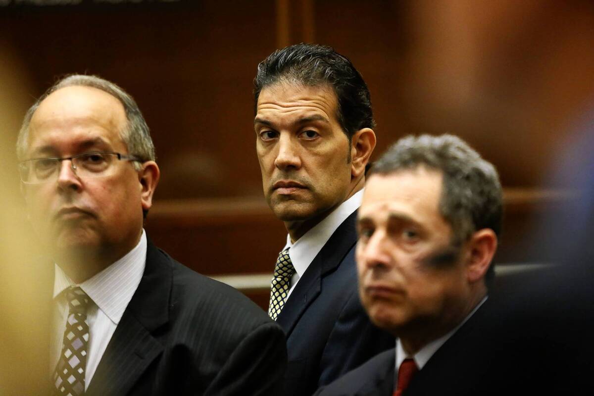 More charges were filed against tax consultant Ramin Salari, center, flanked by attorneys Mark Hathaway, left, and Mark Werksman.