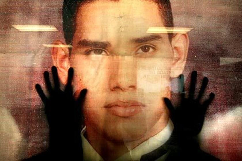 Seen from inside a Baja State government office, Fernando Ocegueda presses his hands on an enlarged photograph of his 23-year-old son. Ocegueda investigated his son's kidnapping on his own.