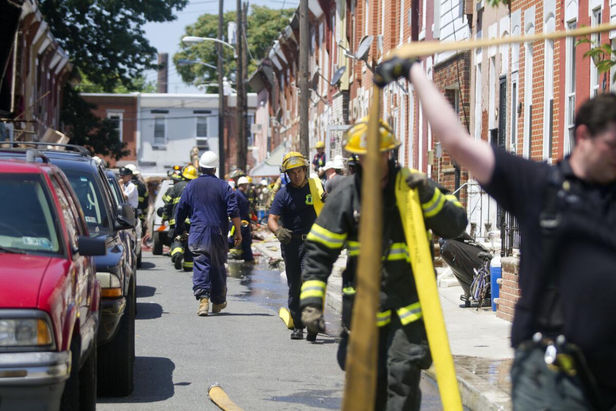 Firefighters respond to a house collapse in Philadelphia.