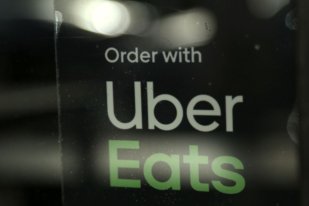 A sign in a window reads "Order with Uber Eats."