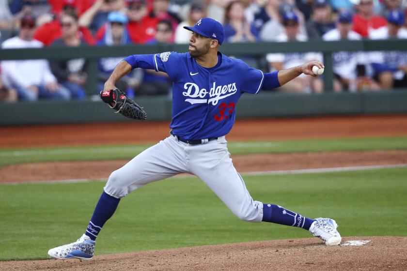 Los Angeles Dodgers starting pitcher David Price throws a pitch against the Cincinnati Reds.