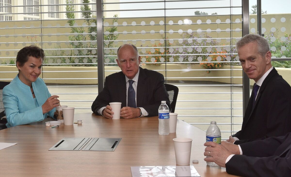William Collins, right, sitting in a meeting with Gov. Jerry Brown and Christiana Figueres, a top United Nations official on climate change.