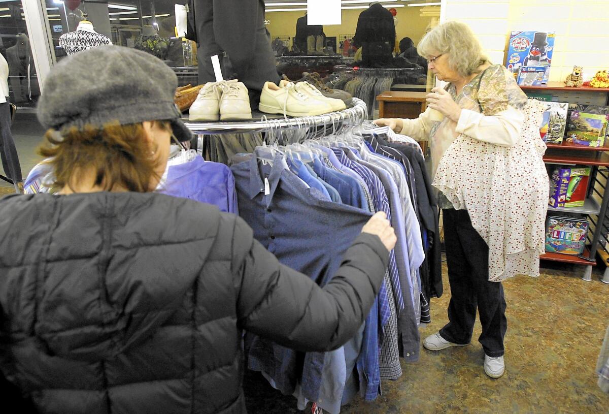 Customers shop at the Working Wardrobes Thrift Shop in Costa Mesa. The nonprofit plans to move its headquarters to a larger location in Irvine. The Costa Mesa shop will remain open.