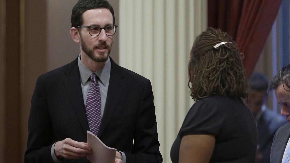 State Sen. Scott Wiener (D-San Francisco), left, talks with Sen. Holly Mitchell (D-Los Angeles) at the state Capitol.