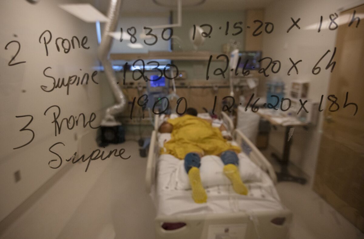 A COVID-19 patient lies facedown inside the ICU at Martin Luther King Jr. Community Hospital.