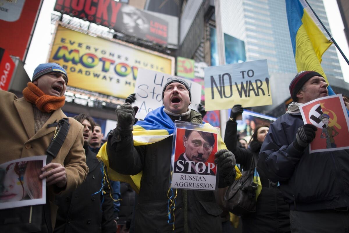 Protesters in New York's Times Square take part in a demonstration against Russian military actions in Ukraine.
