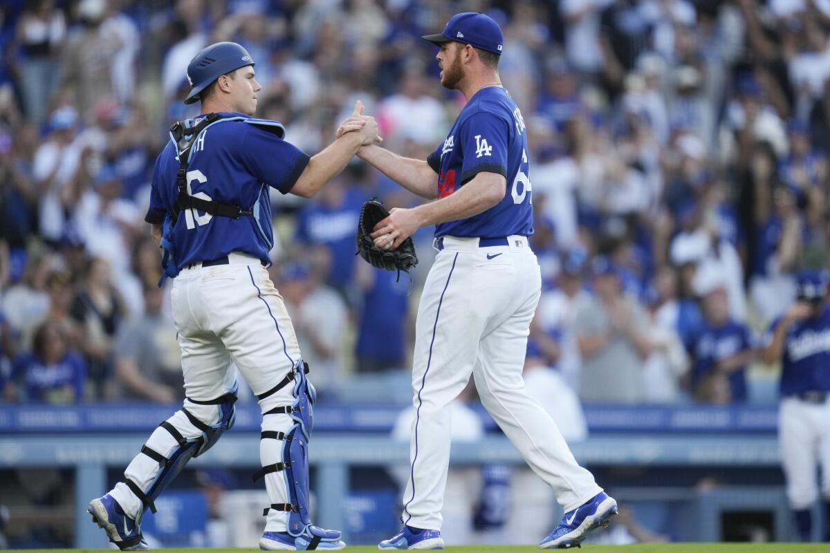 Dodgers catcher Will Smith and reliever Caleb Ferguson celebrate the team's 4-2 win over San Diego on May 13, 2023.