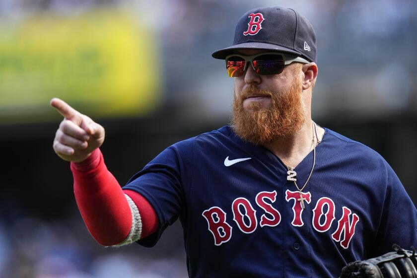 Boston Red Sox's Justin Turner gestures to teammates after a call at home plate was overturned during the eighth inning of a baseball game against the New York Yankees Sunday, Aug. 20, 2023, in New York. (AP Photo/Frank Franklin II)
