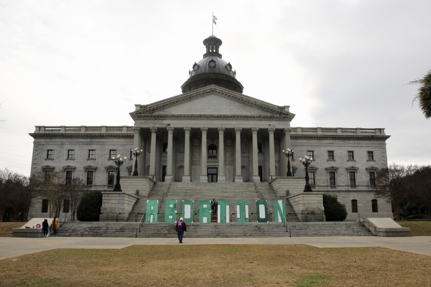 Abortion rights proponents put up a sign spelling out the word abortion in front of the South Carolina statehouse