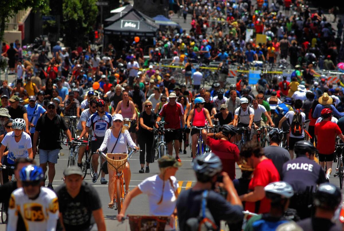 Hundreds of cyclists make their way along Wilshire Boulevard during a CicLAvia event in June 2013.