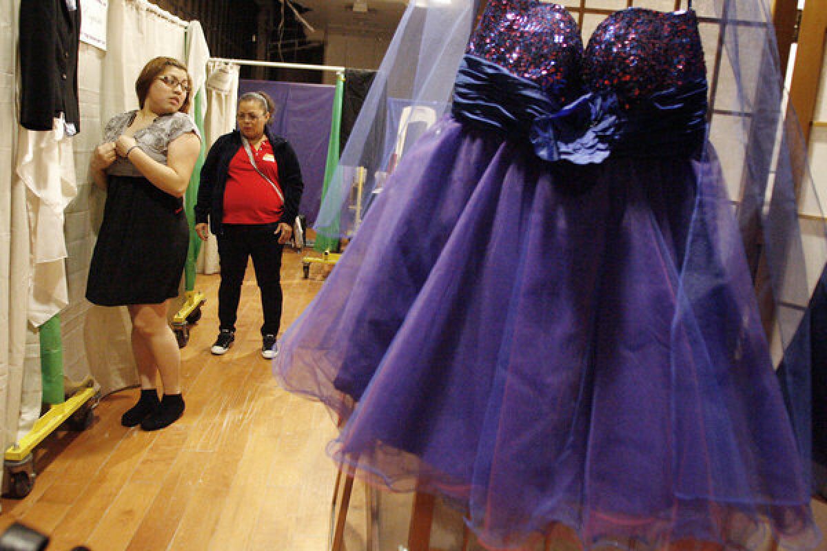 Maria Gamez, right, looks at her daughter, Amy, 19, while she tries on prom dresses during Renal Support Network's makeover day, which took place at the Glendale Galleria.