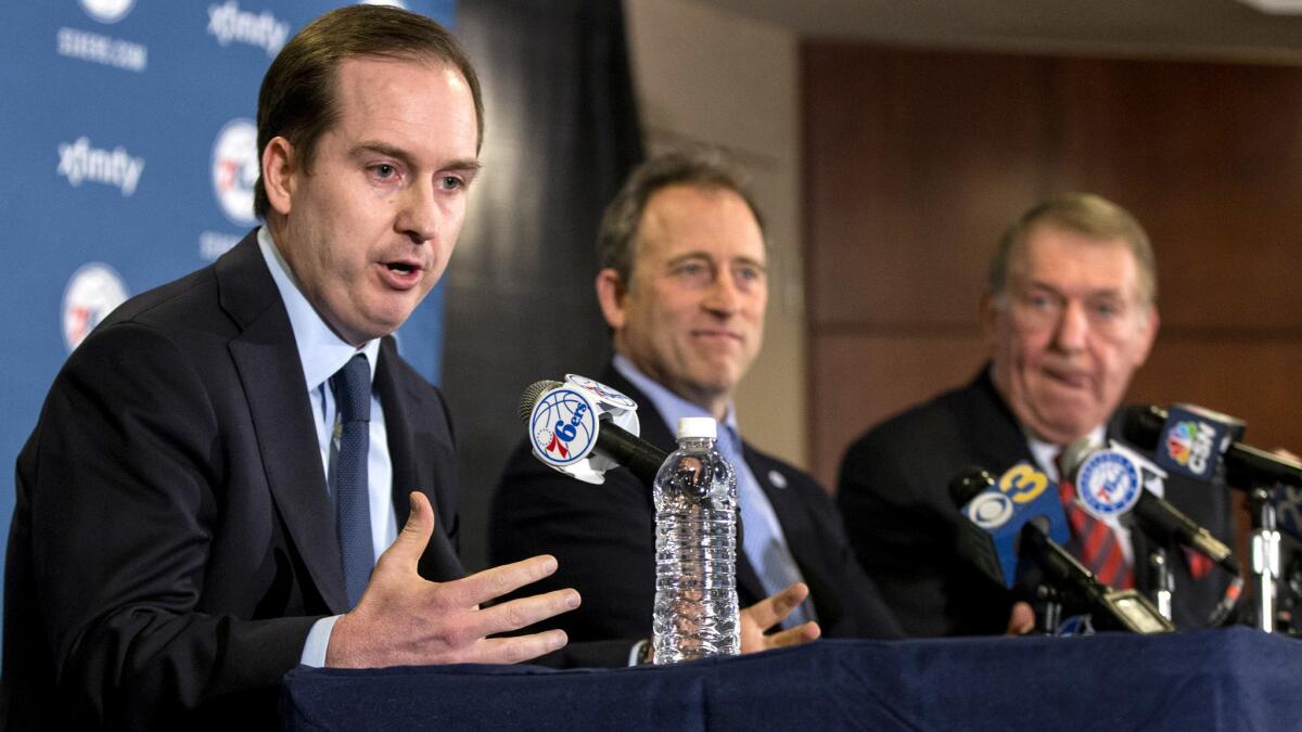 Sam Hinkie fields questions during a December news conference while flanked on the right by 76ers owner Josh Harris, center, and Jerry Colangelo, chairman of basketball operations.