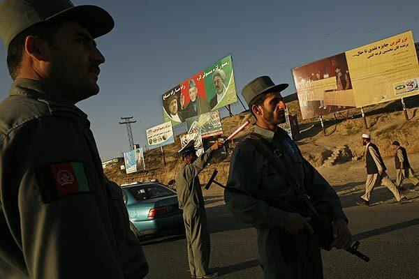 Cars entering Kabul, the Afghan capital, before voting begins undergo scrutiny at a police checkpoint. Seventeen million Afghans are registered to vote in the presidential election.