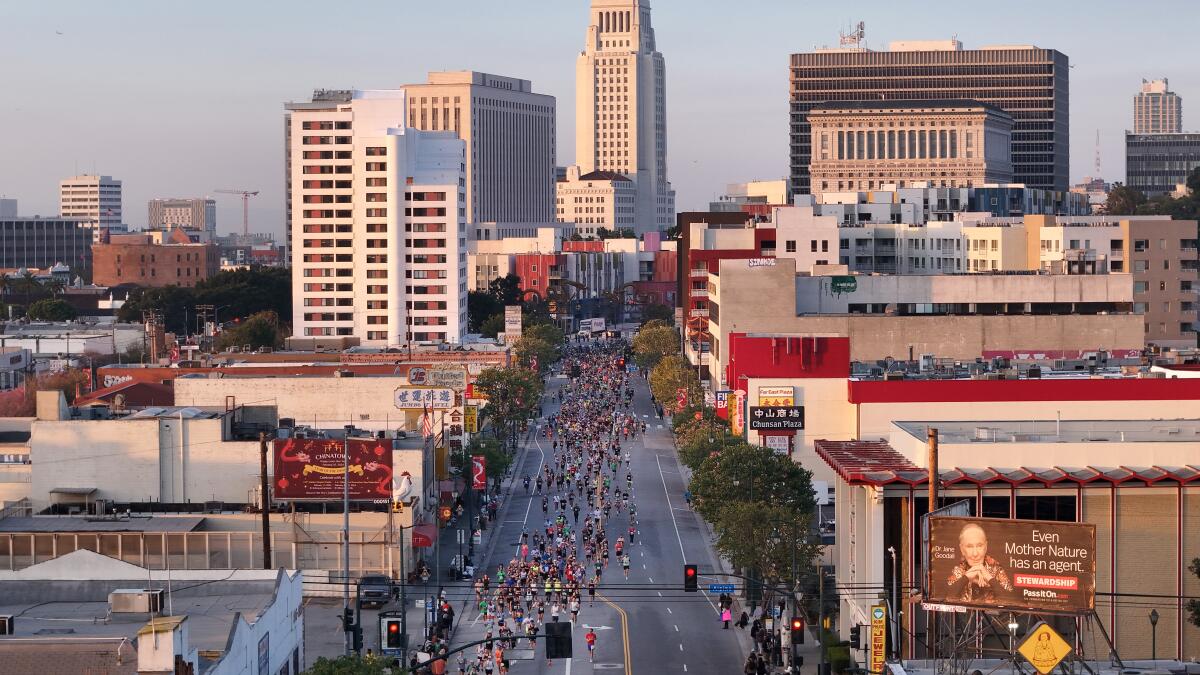 LOS ANGELES, CA- MARCH 17: The LA Marathon makes its way onto Broadway in Chinatown at the two-mile mark on Sunday, March 17, 2024. Over 25,000 runners competed this year. (Myung J. Chun / Los Angeles Times)