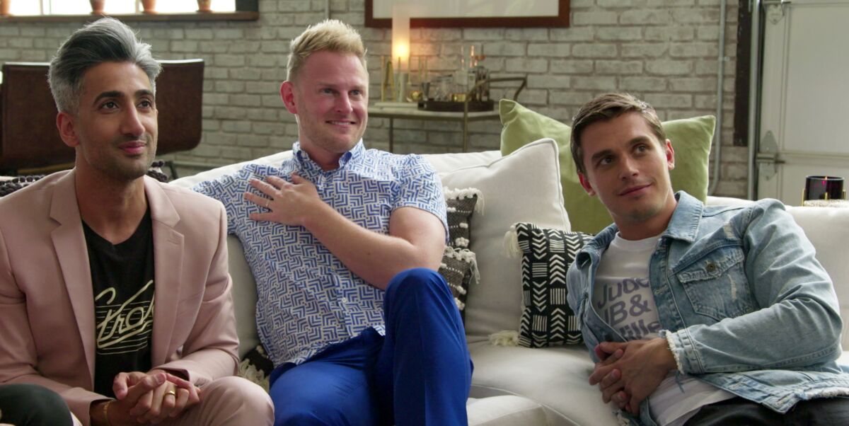 Three people sit on a sectional