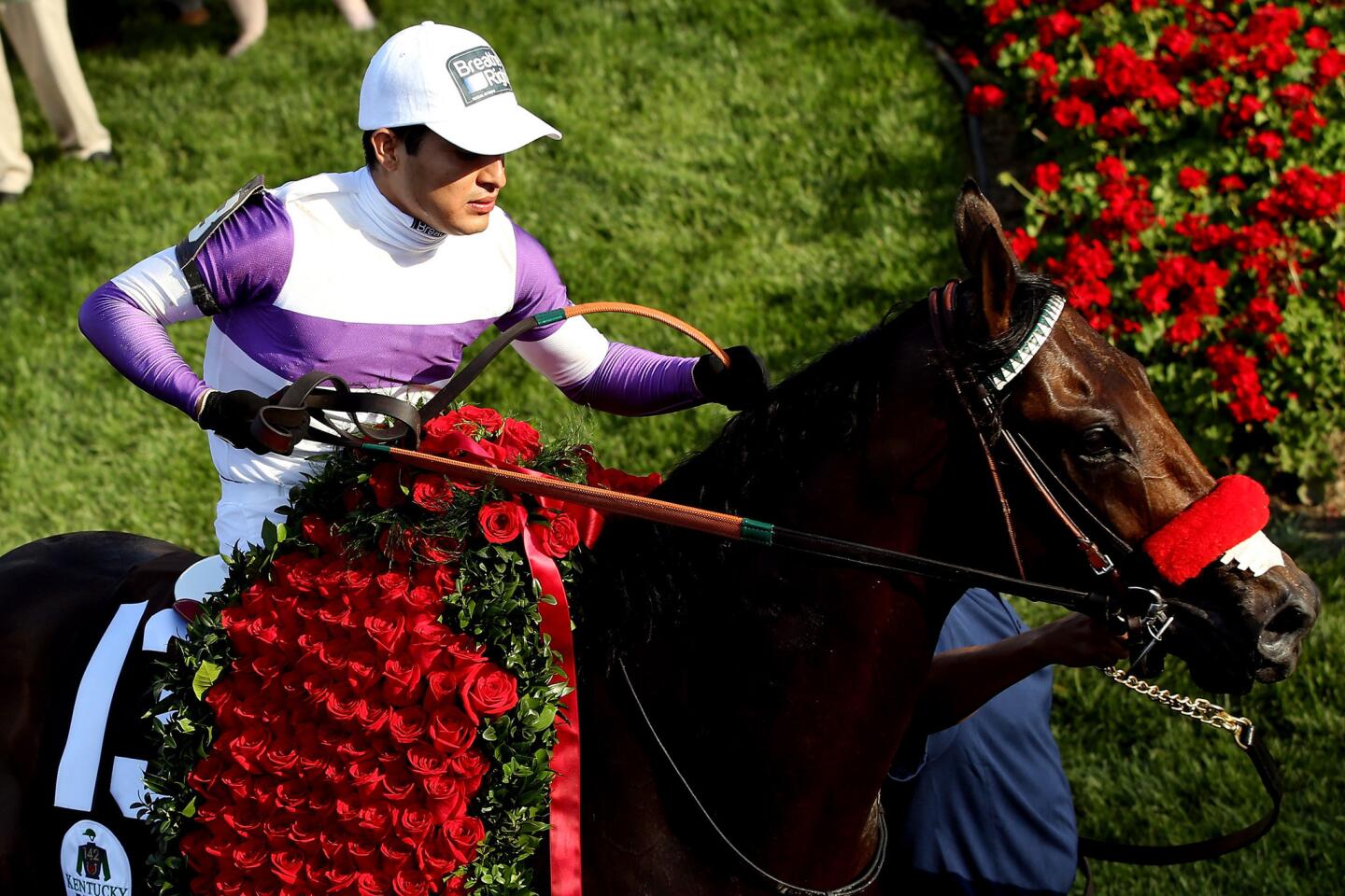 Jockey Mario Gutierrez accepts the blanket of roses after Nyquist won the 142nd Kentucky Derby.