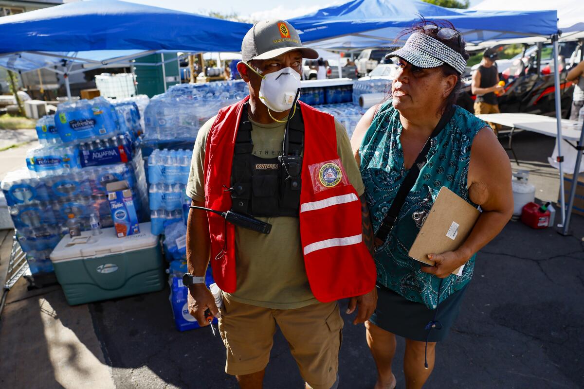 Archie Kalepa and Melissah Shishido gather supplies for Lahaina residents.