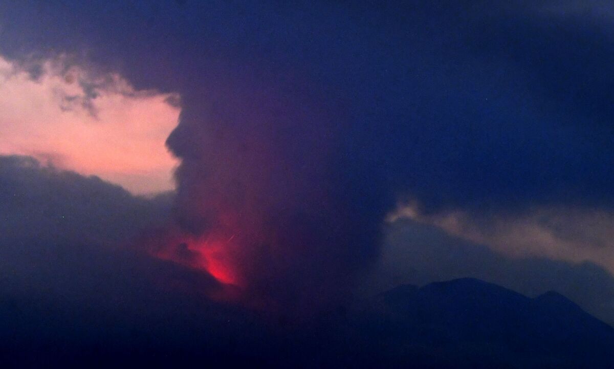 Smoke from a volcano glows with flame