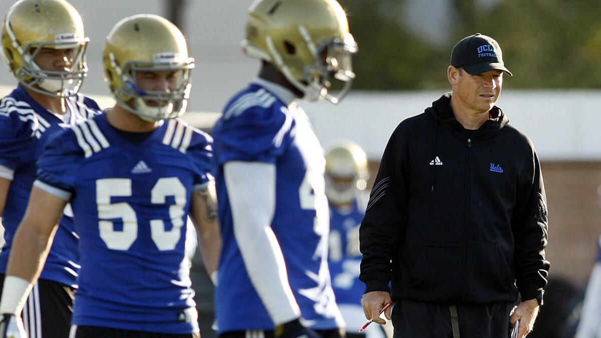 UCLA Coach Jim Mora looks on during a team practice session in Westwood on April 1. Keeping a closer eye on top players outside of California has become an essential part of the Bruins' recruiting strategy.