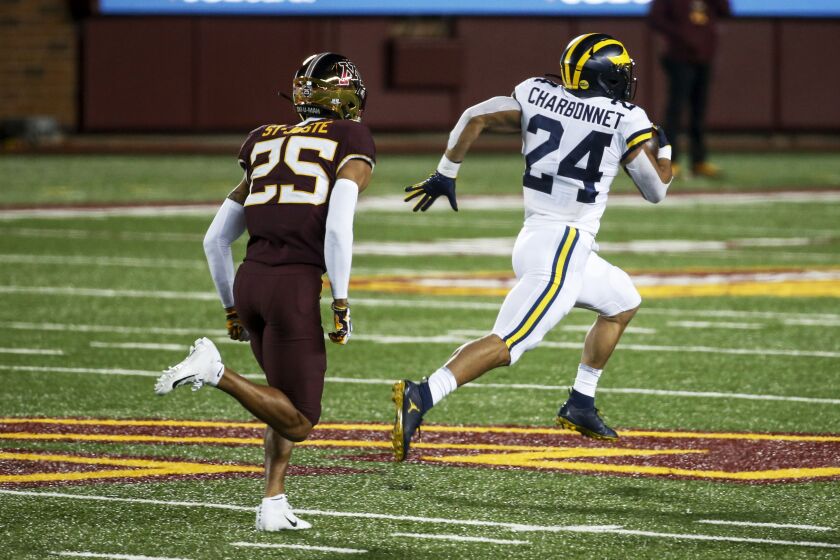 Michigan's Zach Charbonnet breaks away from Minnesota's Benjamin St-Juste for a 70-yard touchdown run Oct. 24, 2020.