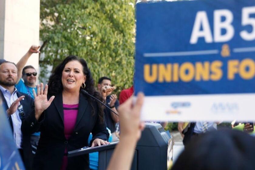 Assemblywoman Lorena Gonzalez, D-San Diego, speaks at a rally after her measure to limit when companies can label workers as independent contractors was approved by a Senate committee, in Sacramento, Calif., Wednesday, July 10, 2019. The measure, AB5, is aimed at major employers like Uber and Lyft. The bill still needs approval by the full Senate. (AP Photo/Rich Pedroncelli)