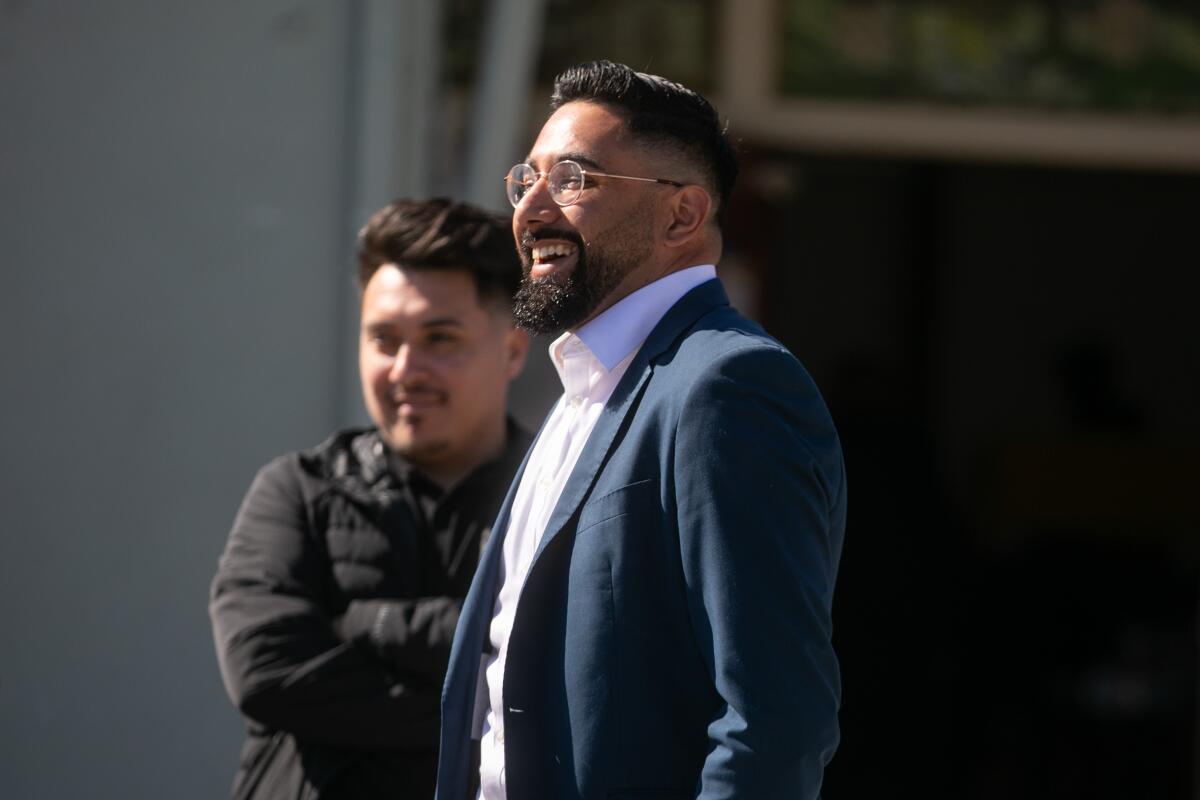 Marco Santana smiles as he arrives to vote.