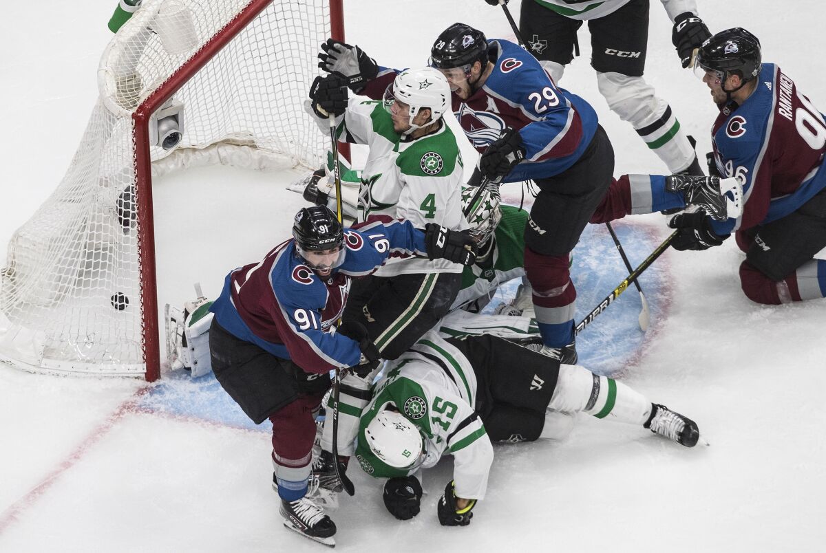 Colorado Avalanche's Nazem Kadri (91) scores against Dallas Stars' goalie Anton Khudobin (35) as Avalanche's Nathan MacKinnon (29), Stars' Miro Heiskanen (4) and Stars' Blake Comeau (15) battle during second-period NHL Western Conference Stanley Cup playoff game action in Edmonton, Alberta, Friday, Sept. 4, 2020. (Jason Franson/The Canadian Press via AP)