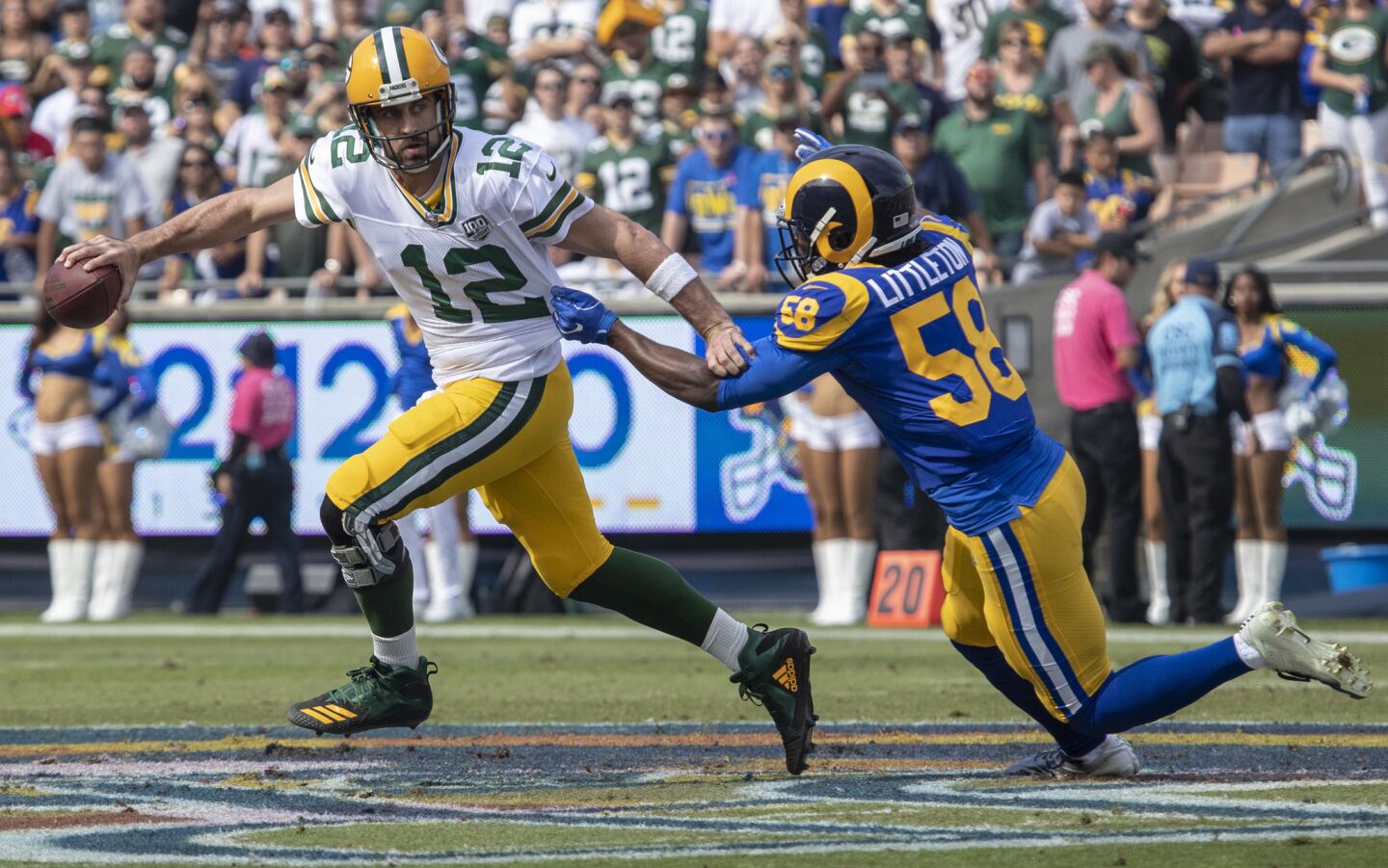 Rams' Cory Littleton, right, sacks Green Bay Packers quarterback Aaron Rodgers in the first quarter at the Coliseum on Sunday.