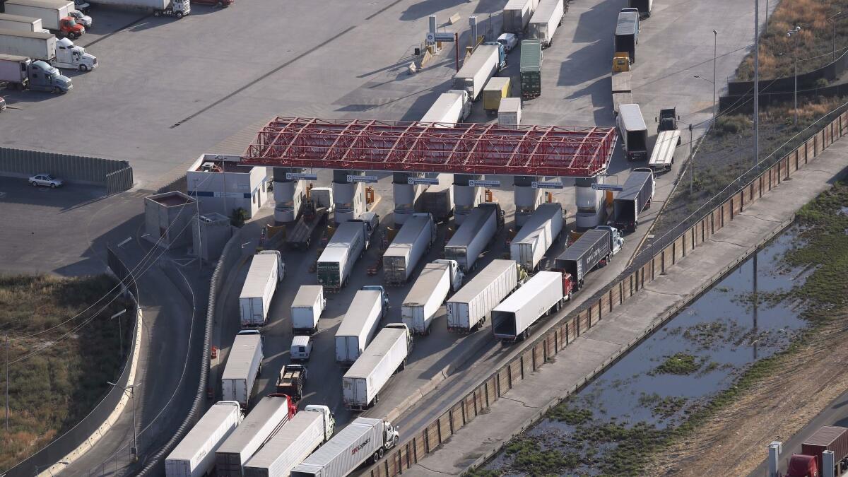 SAN DIEGO, CA - MAY 11: Freight trucks, as seen from a helicopter, pass through Mexican Customs before entering the United States at the Otay Mesa port of entry on May 11, 2017 in San Diego, California.