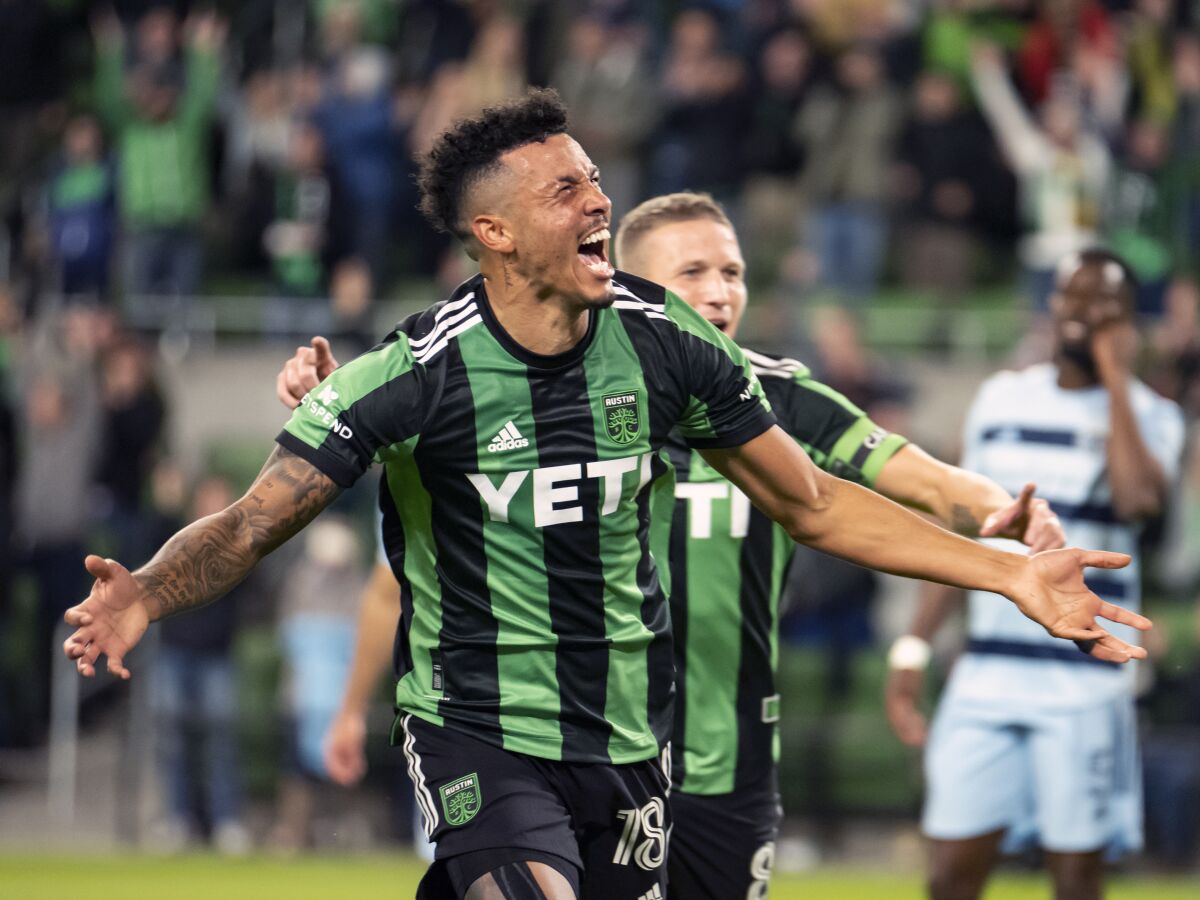 Austin FC defender Julio Cascante (18) celebrates his goal during the first half of the team's MLS soccer match against Sporting Kansas City, Wednesday, Nov. 3, 2021, in Austin, Texas. (AP Photo/Michael Thomas)