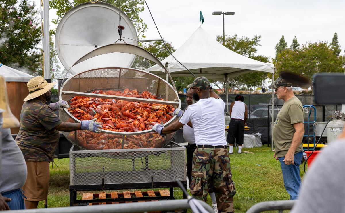 Audiences watch as workers prepare fresh live Maine lobster at the Original Lobster Festival.