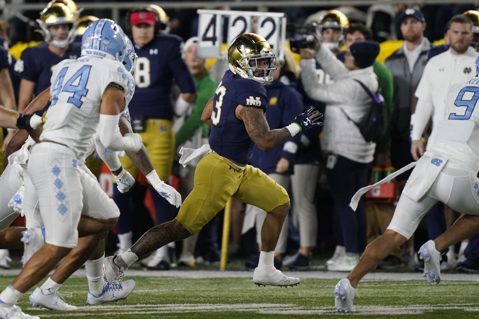 Notre Dame running back Kyren Williams tries to evade North Carolina defenders.