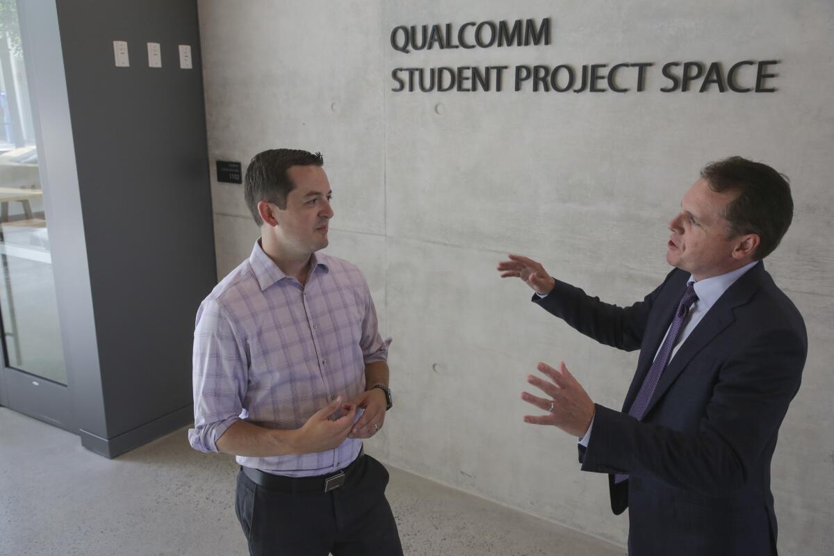 UC San Diego Professor Patrick Mercier (left) discusses ideas with Qualcomm executive John Smee in Franklin Antonio Hall.