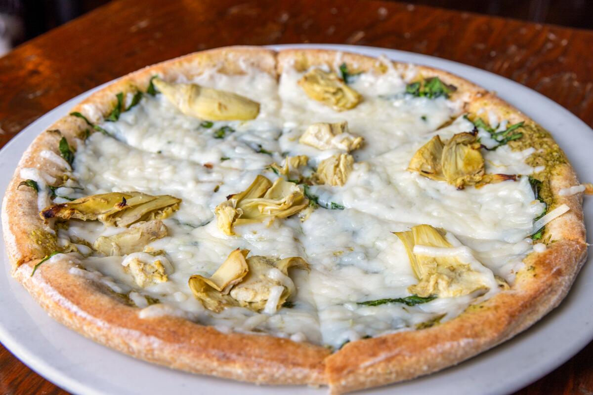 A vegan pizza with spinach artichoke dip currently on the Sage menu.