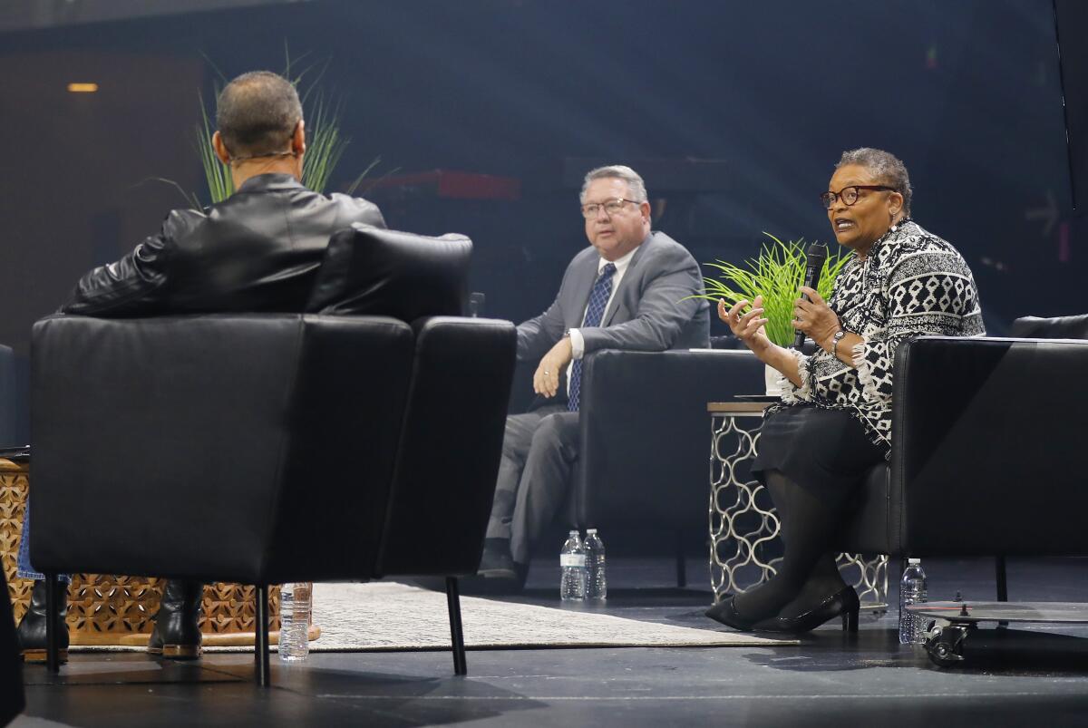 Dr. Wilma Wooten, San Diego County's public health officer, right, was interviewed by Pastor Miles McPherson, left, during a service at the Rock on March 15, 2020. El Cajon Mayor Bill Wells looks on.