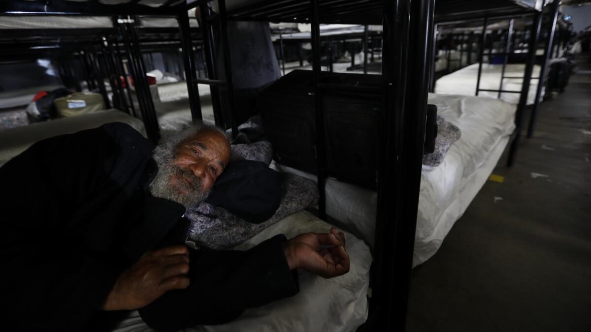 Bobby Washington, 60, rests on his bunk Volunteers of America shelter in South Los Angeles, CA April 18, 2018. He says he has been homeless for several years.